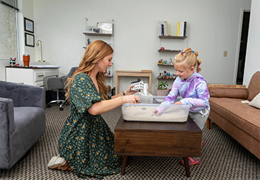 therapist playing with young girl