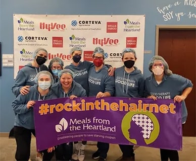 Mission-Community_16-min Group of people in hairnets with Meals from the Heartland