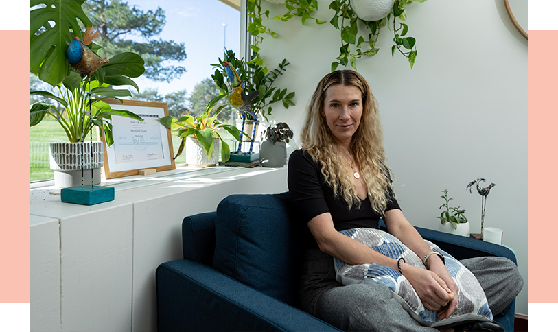 Our-Team_meredith Meredith sitting in room with plants
